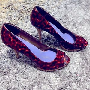 Size 8 Nine West leopard patent leather open toed, cork accented high heels.